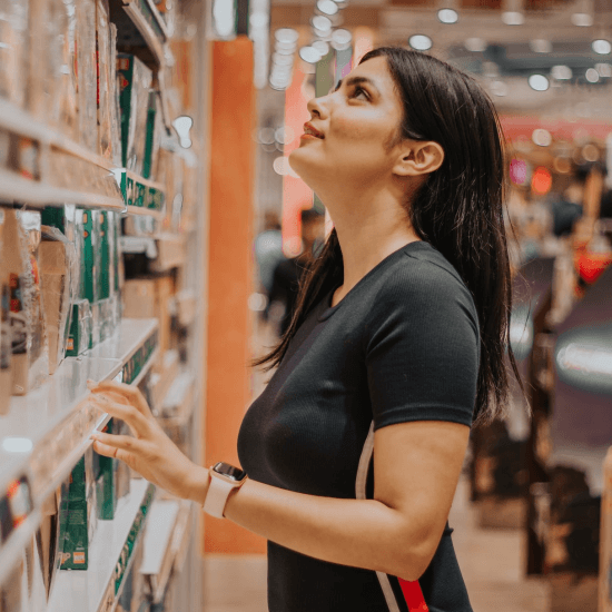 Woman looking at items on store shelf